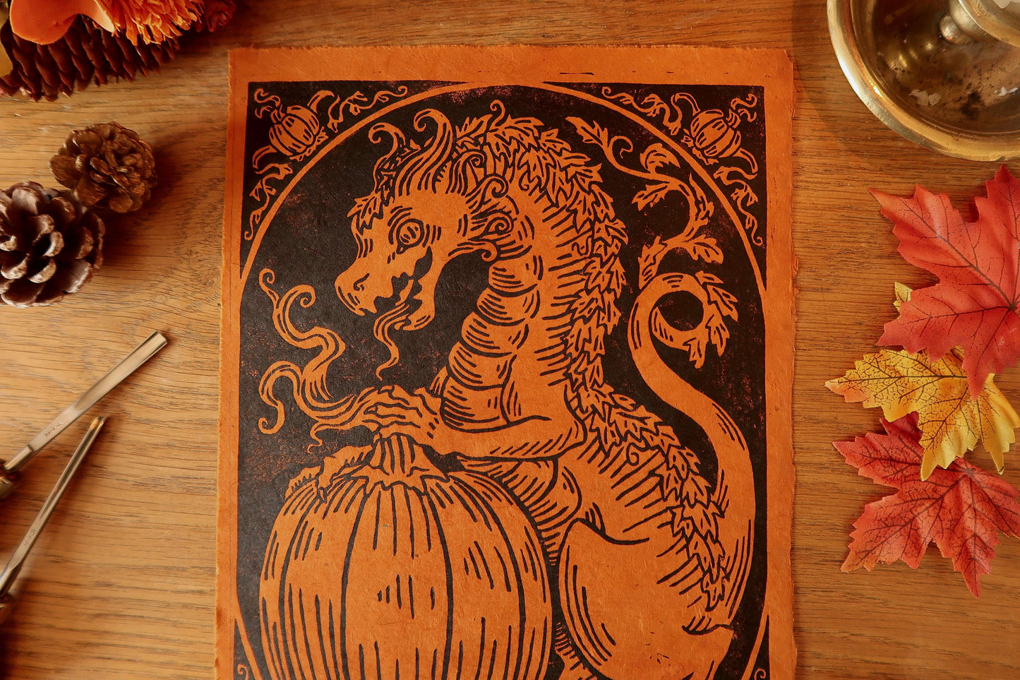 Pumpkin dragon 1- Linocut print on Burnt orange