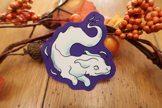 Purple and white sticker with a design of a ghost dragon on a wooden surface with decorative elements.